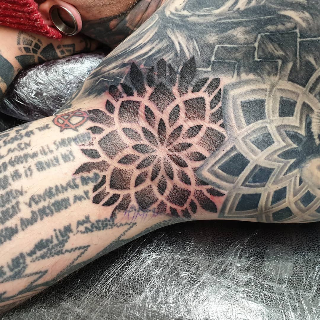 Mandala tattoo on the right inner forearm