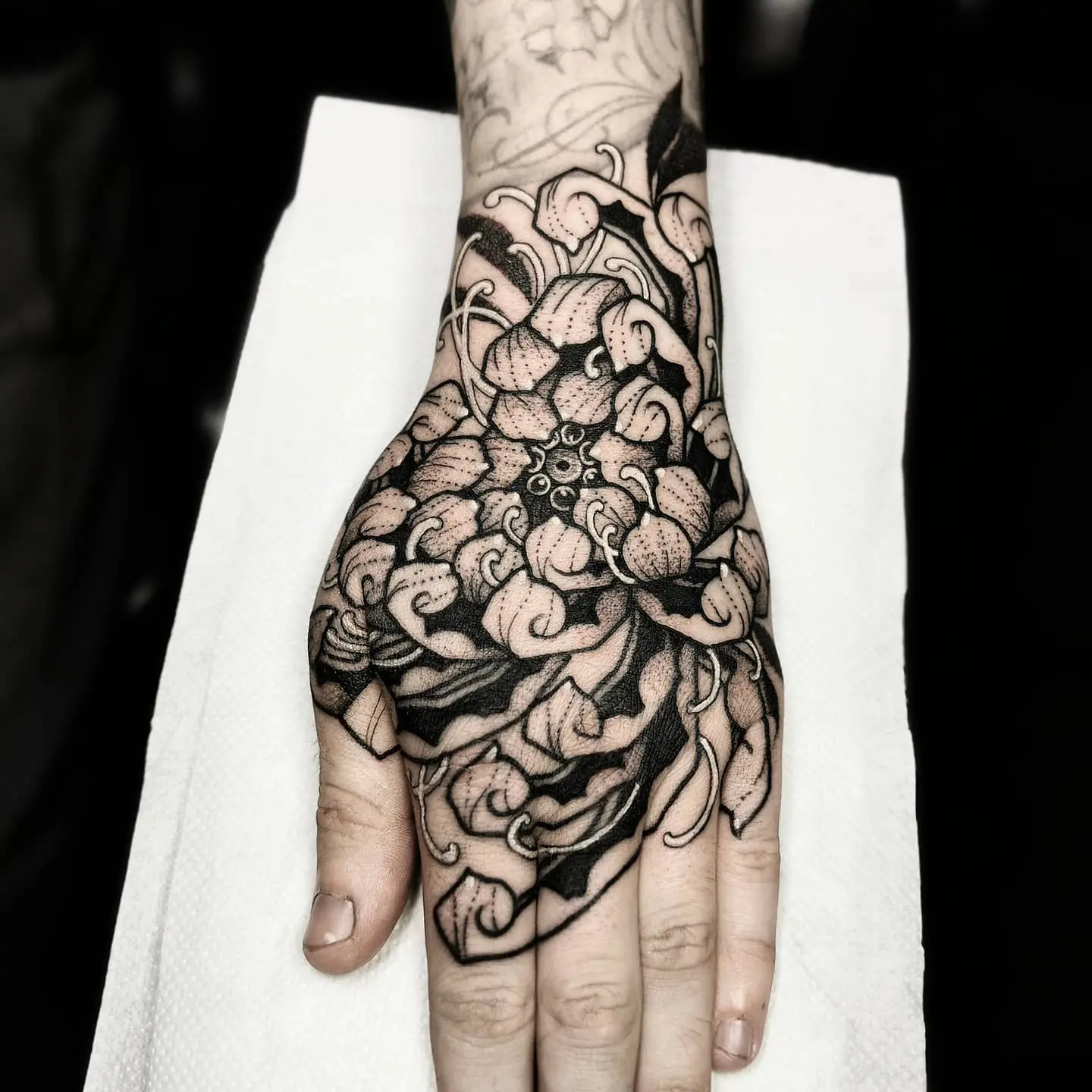 Blackwork Flower In Hand Tattoo  TATTOOGOTO