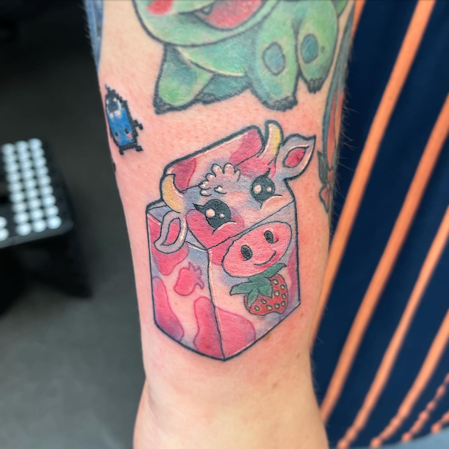 Strawberry cow, stunning! Closing some gaps on Lauren’s adorable sleeve in progress. 
Lots of fun with the tiny Junimos. Glad we could continue your birthday tradition of getting tattooed and lovely banter!

                     